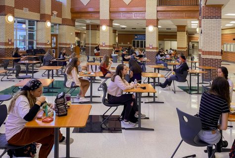 Sophomores Brinly Eaton, Natalia Duran De La Bega, Jillian Nuckles, and freshman Gianna Bierman eat lunch in the newly organized cafeteria. All desks are separated and face one way to promote social distancing. 