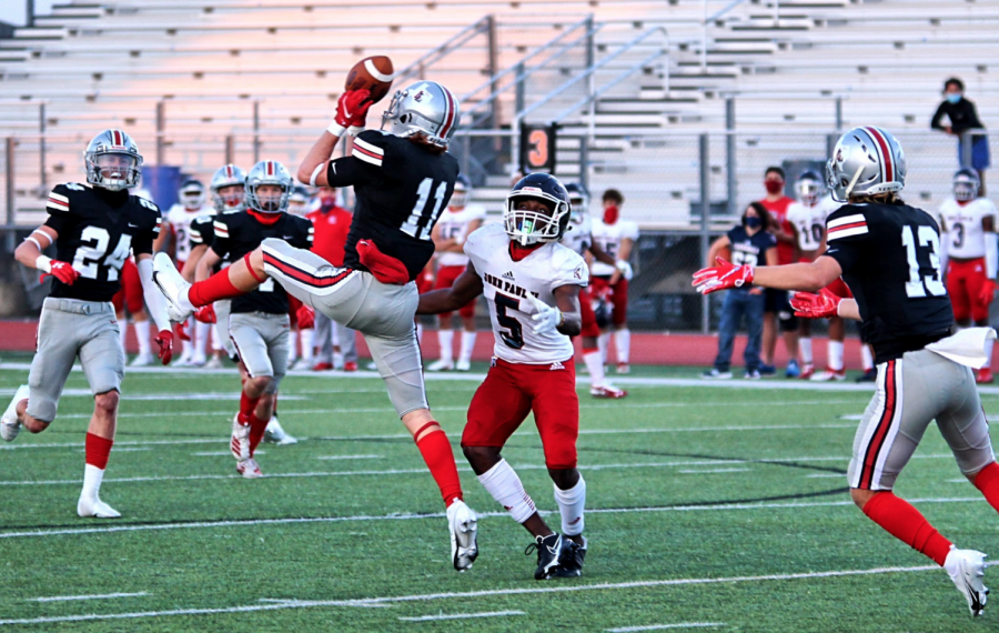 Senior safety Chief Collins elevates to intercept a pass from John Paul IIs quarterback Hayden Ferguson in the opening drive. John Paul II threw four interceptions in the game.