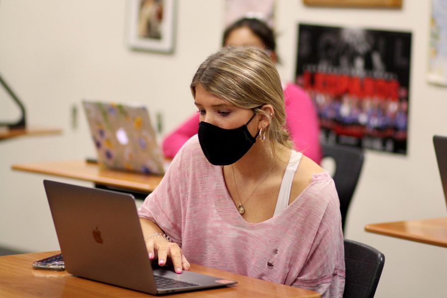 Junior Mazie McGoldrick listens to her classmates on Zoom. Students take precautions in classrooms to help prevent the spread of the coronavirus.