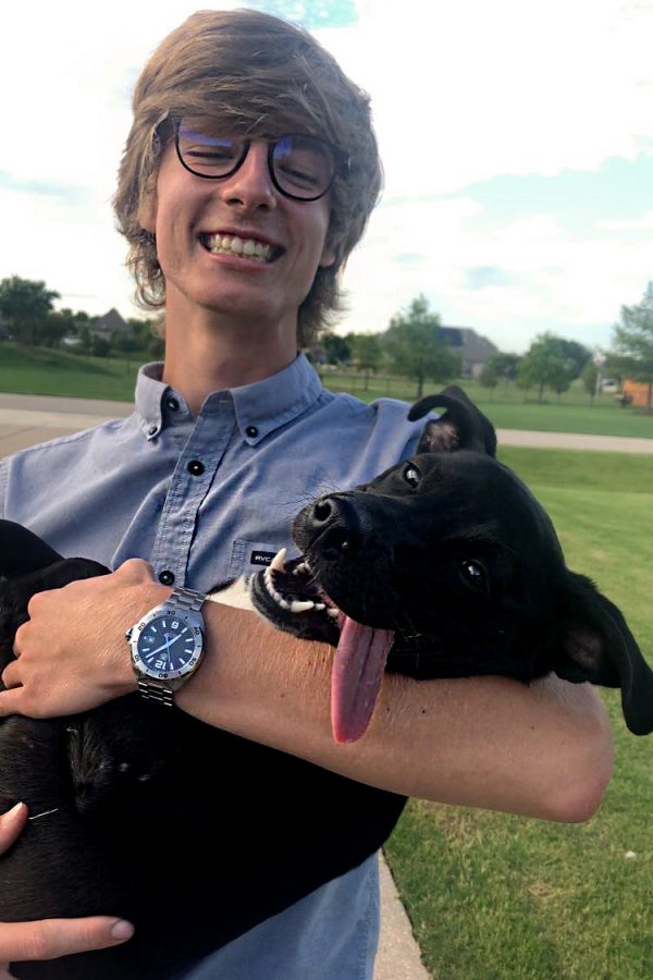 Senior Braden Schlimme holds the dog that him and his father rescued from a parking lot.