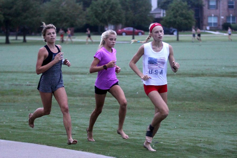 Sophomore Amy Morefield and freshmen Sara Morefield and Kaley Littlefield run at practice. The cross country team will compete at the Keller Invitational on Oct. 3. 