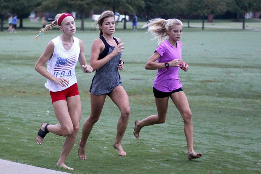 Freshmen Kailey Littlefield and sophomore Amy Morefield run around Celebration Park. Littlefield competed in one of the most competitive track meets in the country this last summer.  