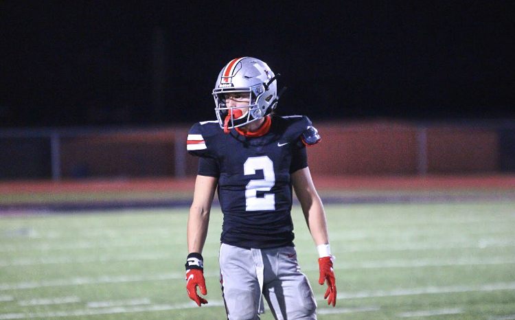 Sophomore Jaxson Lavender looks to his teammates before the next play of the game. Lavender is the starting wide receiver for the Leopards. 