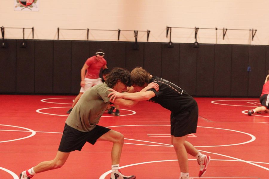 Seniors Jack McKinney and Dalton Braun practice by doing a wrestling drill. The wrestling team's duel and tournament season starts next semester. 