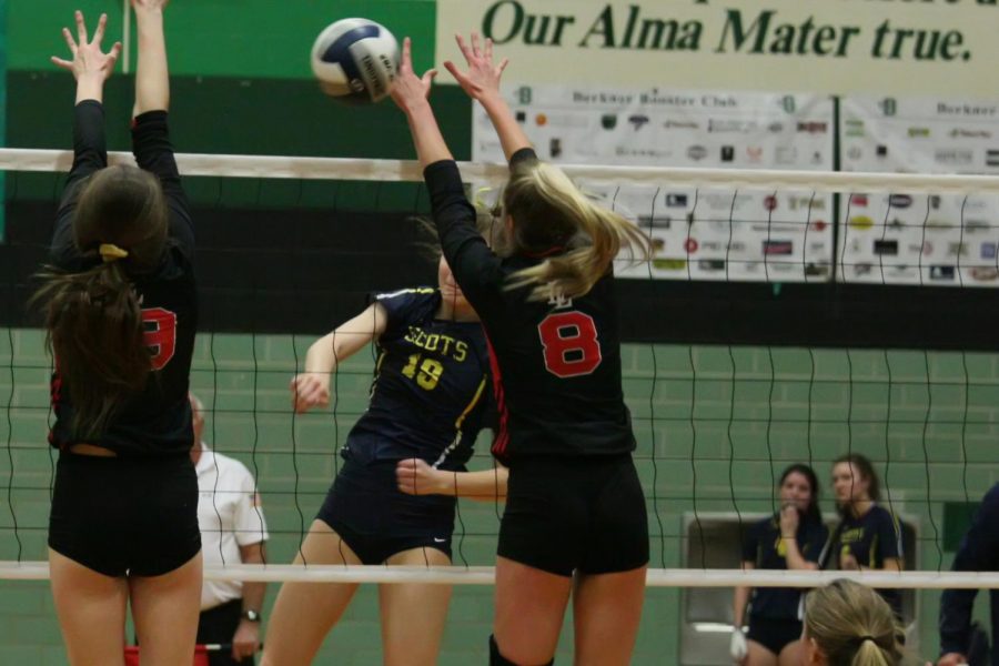 Senior Brynn Egger blocks the ball after an attempted spike onto the Leopards. Egger plays as a middle for Lovejoy.