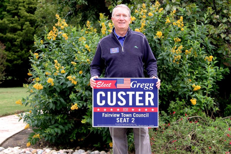 Gregg Custer holds his campaign sign. He is one of six Fairview citizens running for town council. 