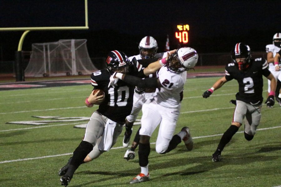 Senior Ralph Rucker runs past a Princeton defensive player. Rucker is the starting quarterback for the Leopards. 
