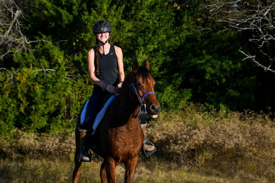 Senior Anna Iovinelli rides in on her horse after an eight mile ride. Iovinelli rode in the Trace the Trail competition. 