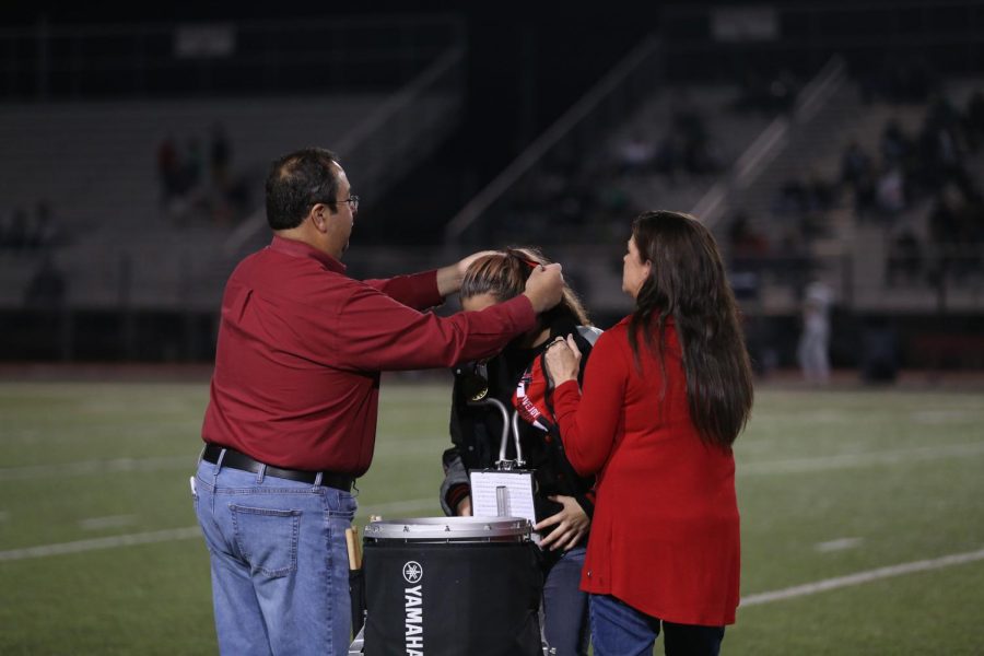 Senior Kerris Vela receives a medal for doing band all four years of high school. Vela is the drum captain for the school band. 
