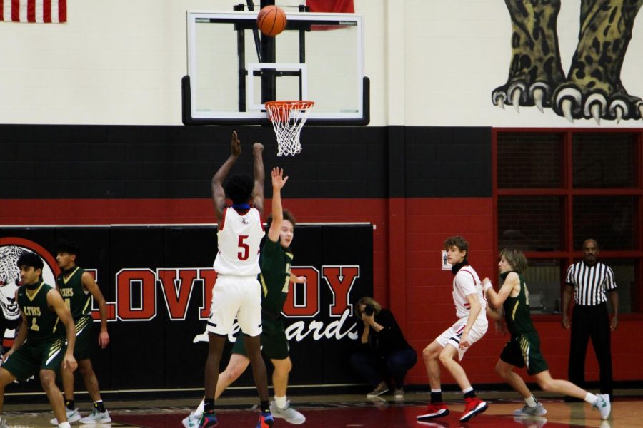 Junior Kidus Getenet makes a three-point shot in the second quarter. The Leopards begin district play on Tuesday, Jan. 1.