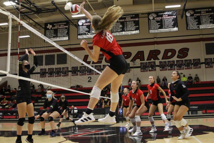 Junior Megan Diercks hits the ball for the return. The return wins the Leopards the point.