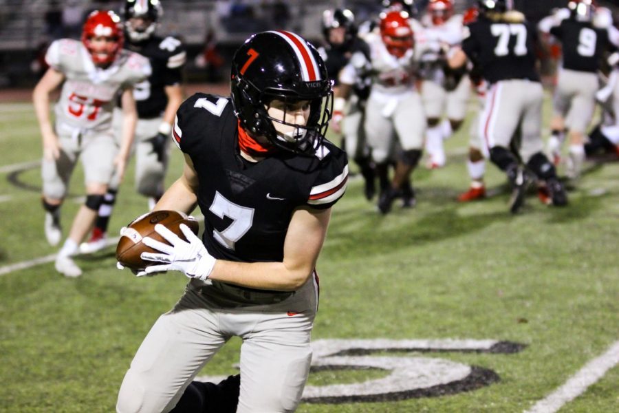 Senior receiver Reid Westervelt runs the ball after a reception on a pass from senior quarterback Ralph Rucker. Westervelt extended the ball over the 48 yard line for a gain of six yards.

