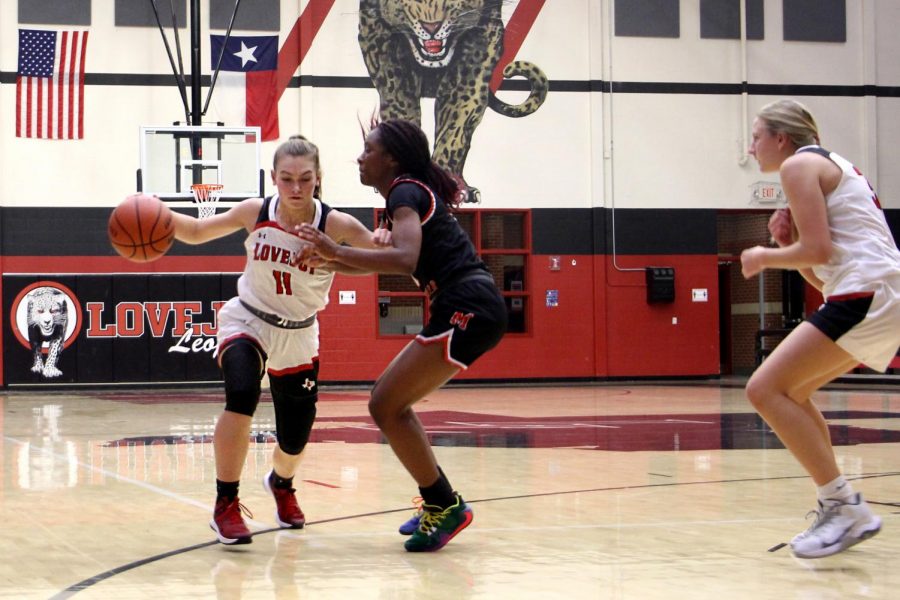 Sophomore Chloe Schaeffer dribbles around the defender towards the basket. Schaeffer attempts a shot after passing the defender.