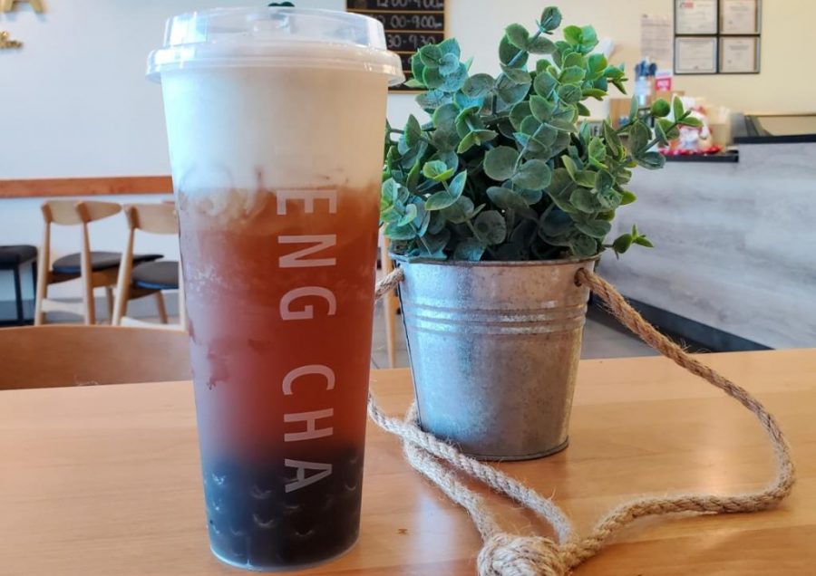 Feng Chas earl grey milk tea is placed next to a simple house-plant in a tin pail, which can be found on each table. The plants add to the aesthetic of the shop.