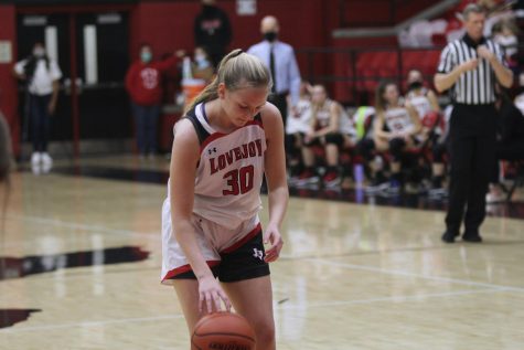 Sophomore guard no. 30 Linnea Maddux dribbles in place before shooting her free throw. Maddux scored two points for the Leopards.