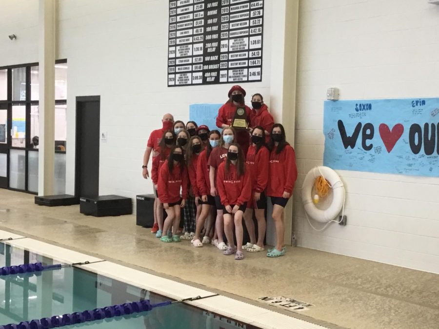 Girls+varsity+swim+team+captain+Amelia+Poulton+holds+the+district+championship+plaque++after+the+team+won+the+meet.+This+is+the+second+year+in+a+row+that+the+team+has+won+the+district+meet.+