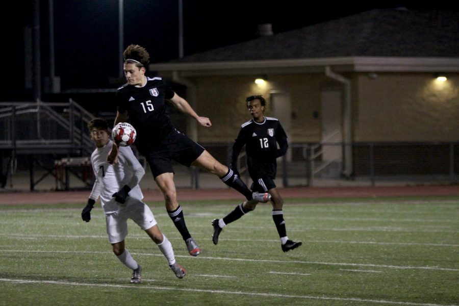 Senior defender no. 15 Gavin Goodrich chest bumps the ball. The team will play their next game against the Princeton Panthers. 