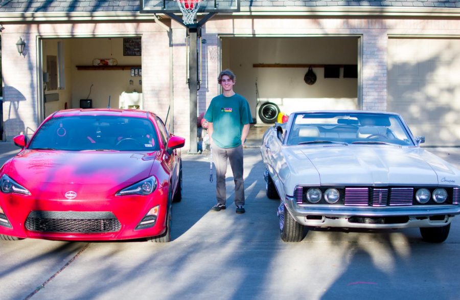 Junior Brendan burner stands next to his white 1969 Mercury Cougar Convertible and his red 2013 Scion FR-S. He bought the Mercury Cougar from his grandfather and has been working to get the car back together and working again.