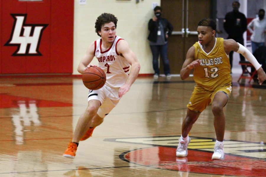 Senior guard no. 2 Mitchell Weaver dribbles past South Oak Cliff’s no. 12 Xavier Cato. The Golden Bears knocked the Ball out of bounds so the Leopards were given a baseline inbounds. 
