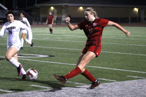 Sophomore left outside defender no. 16 Emmy Wood kicks the ball past Princetons Justice Peinado. The girls soccer team will play their next game against the Wylie East Raiders tonight. 
