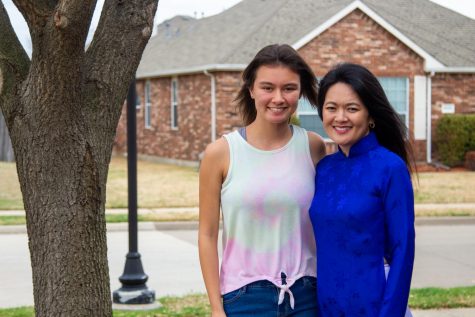 Junior Sydnee Taylor stands with her mother, Uyen, who is wearing traditional Vietnamese clothing. Uyen moved from Vietnam to the United States when she was 8 years old.