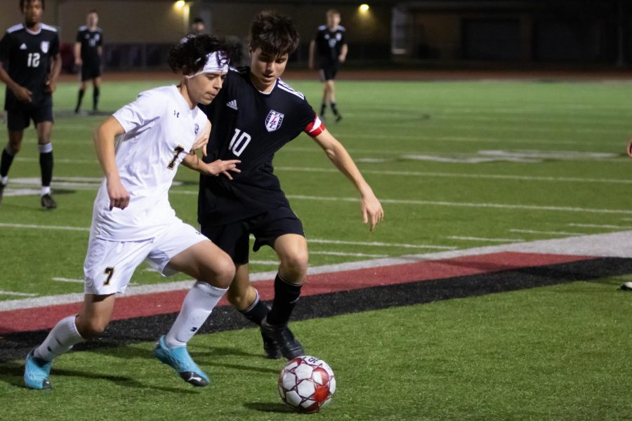 Junior midfielder no. 10 Michael Beaney attempts to steal the ball from junior midfielder no. 7 Giovanni Garcia. This win put the Leopards first in district. 