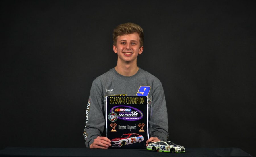 Freshman Hunter Hayward holds his Nascar Diecast championship award. Hayward received a sponsorship from PlanBSales for his virtual racing. 