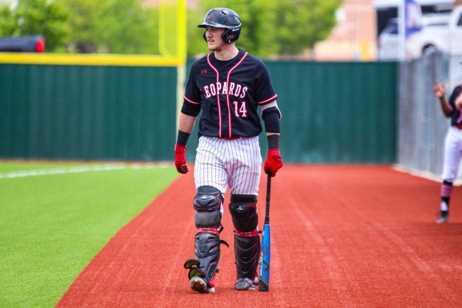 Senior catcher no. 14 Ralph Rucker walks up to the on deck circle wearing his leg guards in case of retired sides during junior center fielder no. 13 Aidan Smith’s at bat. Coming into the game, Rucker had a five game RBI streak and was named co-offensive player of the week by his coaches. 