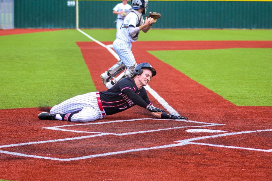 Junior left fielder no. 2 Trent Rucker dives into home plate to give the team a 4-3 lead in the top of the fifth inning. Rucker’s run came after a hit to left field by senior catcher no. 14 Ralph Rucker, the hit was Ralph Rucker’s second RBI of the game. 