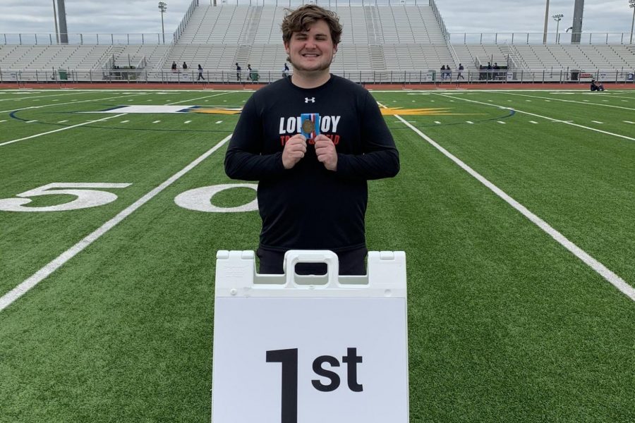 Senior Mason Stein holds his first-place medal after competing in the shot put event at the area track meet. Stein threw 512 at this meet to take the win. 