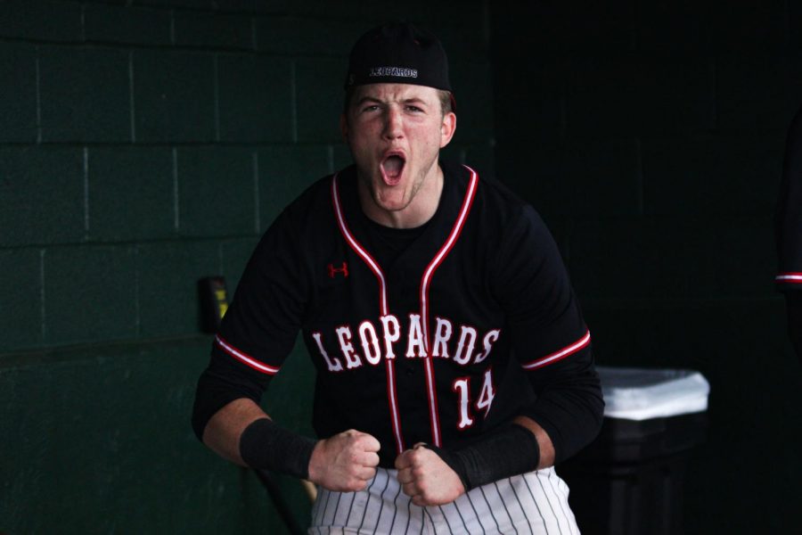 Senior catcher no. 14 Ralph Rucker celebrates in the dugout after a base hit from freshman right fielder no. 23 Matthew Mainord. Junior center fielder no. 13 Aidan Smith scored on the hit and during the throw home Mainord advanced to second base.