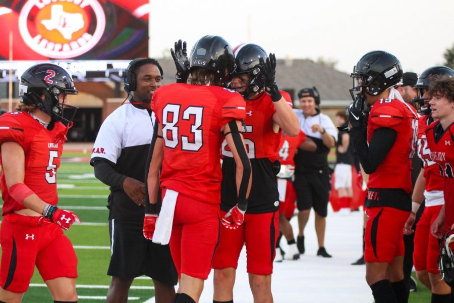 Senior tight end no. 25 Lane Droupy cheers on sophomore wide receiver no. 83 Parker Livingstone. Livingstone scored one of the touchdowns of the game. 