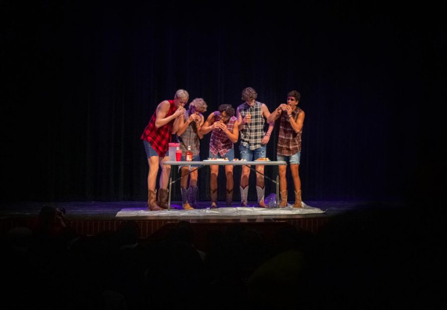During senior Derek Dangs Mr. Lovejoy performance, he and juniors Karson Templin, Jack Terwege, Will McLaughlin, and Parker Patel attempted to each eat three hotdogs on stage. The four juniors are all a part of the Dirty Drumline.