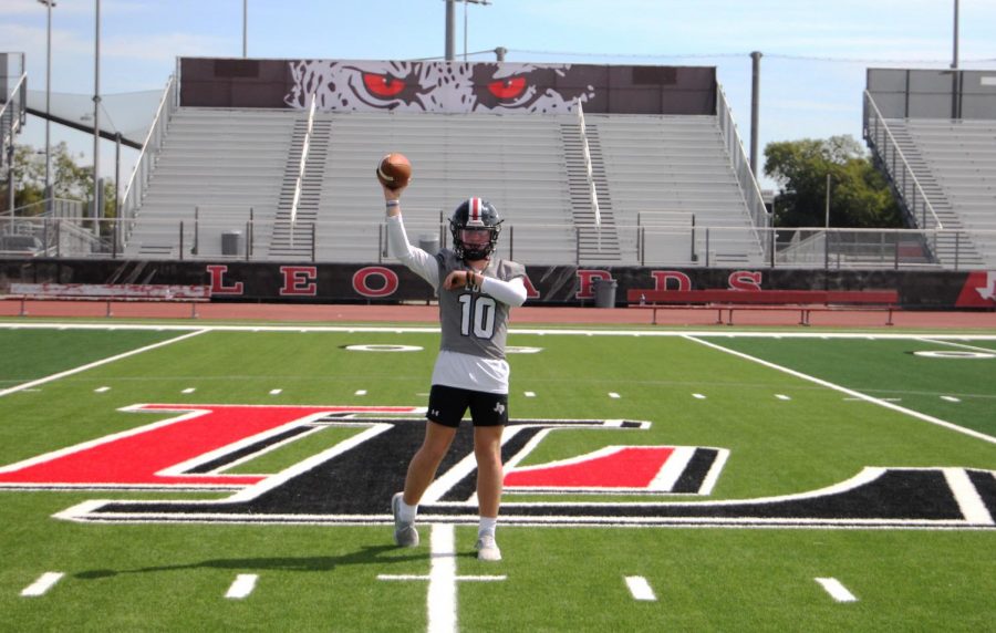 Sophomore Alexander Franklin stands at mid-field passing the football. Franklin is the varsity starting quarterback.