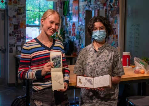 Seniors Jenna Garcia and Ella Reaugh recived perfect scores on their AP Art exam this past year. Both are holding their art book studies, where they deeply study nature as they draw it.
