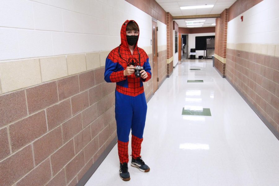 Senior Dominic Mauriello assumes the cowl of Spiderman. He holds a camera from Peter Parkers job at the Daily Bugle. 