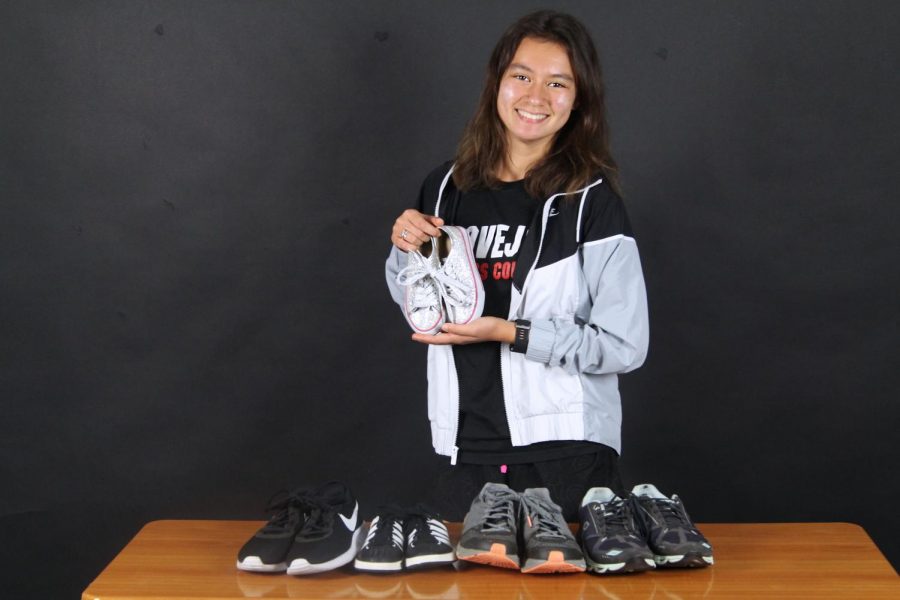 Senior Sydnee Taylor shows off the shoes she has collected. Taylor is coordinating a shoe drive for her senior project. 