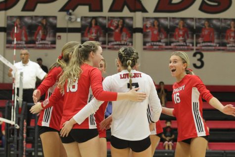 The Leopards celebrate as senior outside hitter no. 18 Megan Dierecks scores a point. The Leopards played against the Colony and won all three sets.