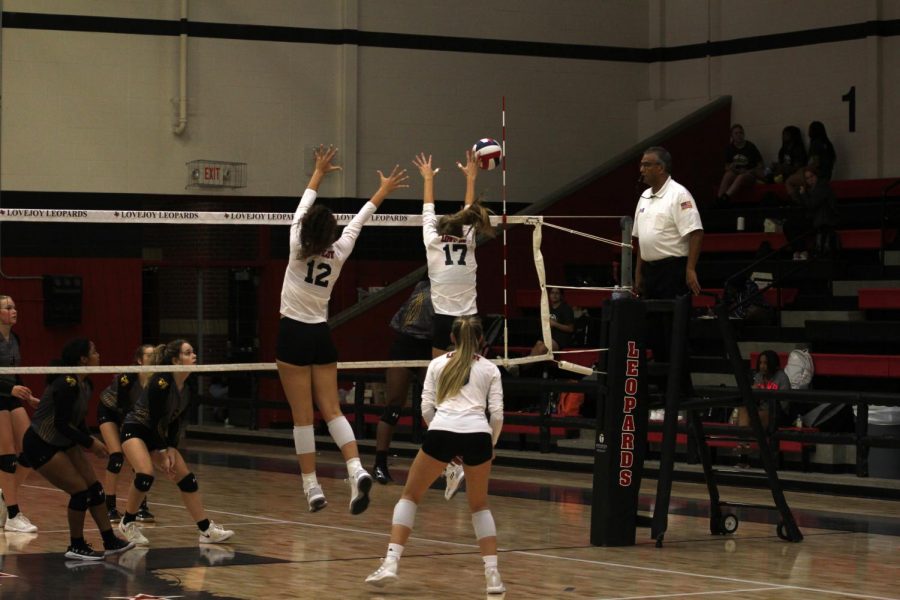 Sophomore hitter no. 12 Hannah Gonzalez and senior setter no. 17 Rosemary Archer jump up to block. The Leopards will play Rock Hill on Friday.