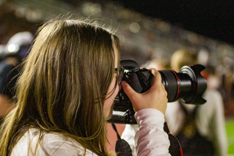 Sophomore+Ava+Cappotelli+takes+photos+at+the+Leopard+Friday+football+game.+Cappotelli+started+her+own+business+taking+photos.