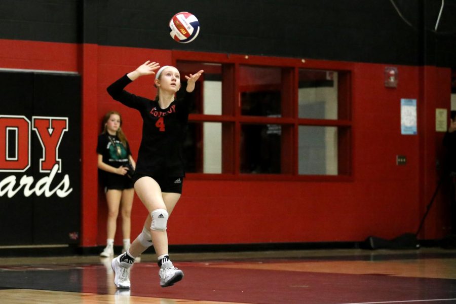 Senior defensive specialist no. 4 Maci Perkins serves the ball. The Leopards won the last set of the game 16-14.