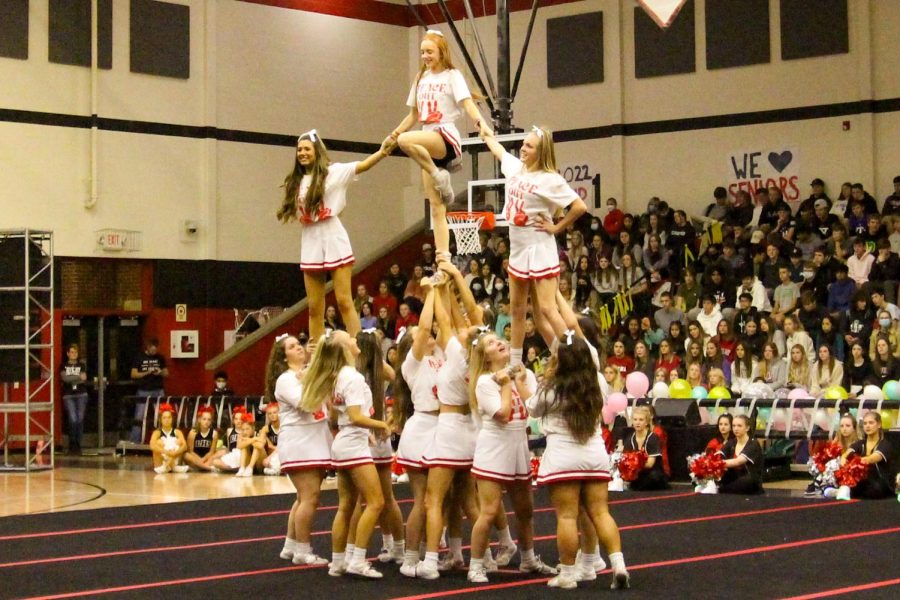 The senior cheerleaders perform a pyramid at the senior pep rally. Senior Claire Traylor is at the top of the pyramid.