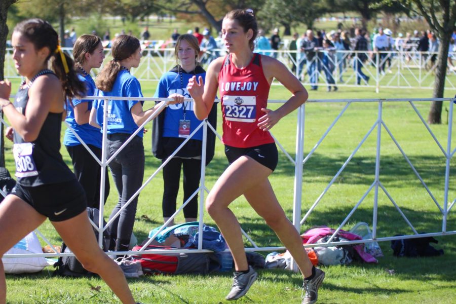 Sophomore Kate Carlson tries to pass the girl infront of her. Carlson came in 66th with a time of 19:36.