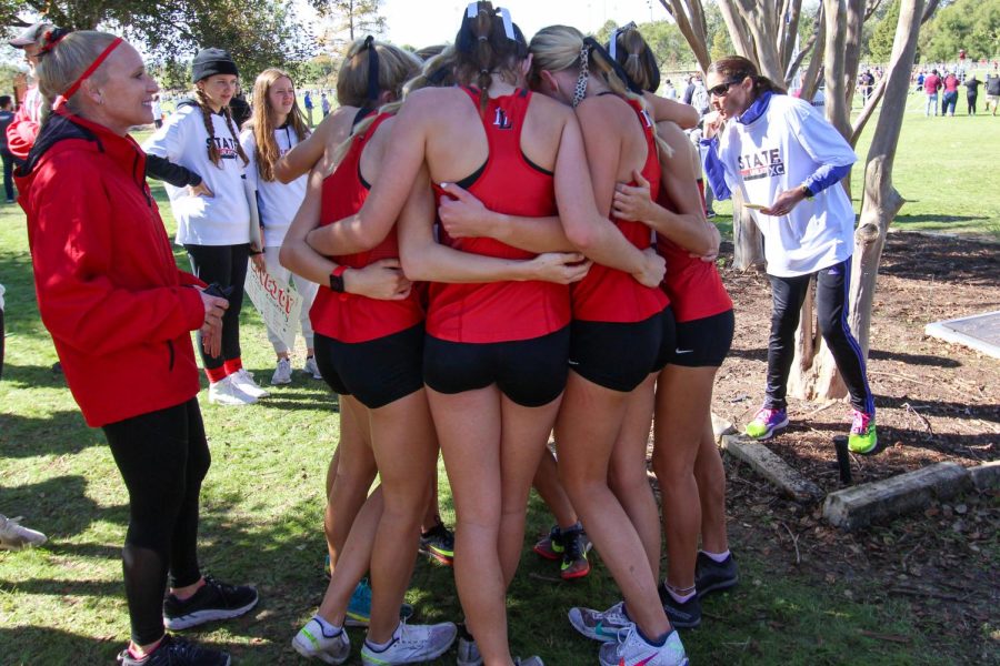 The girls team hug after finding out they won state. The second-place team came in six points behind them.