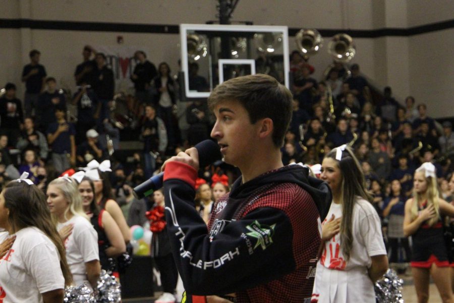 Senior Aidan Abramson sings the national anthem at the beginning of the pep rally. Abramson participates in the schools acapella group and the fishing team.