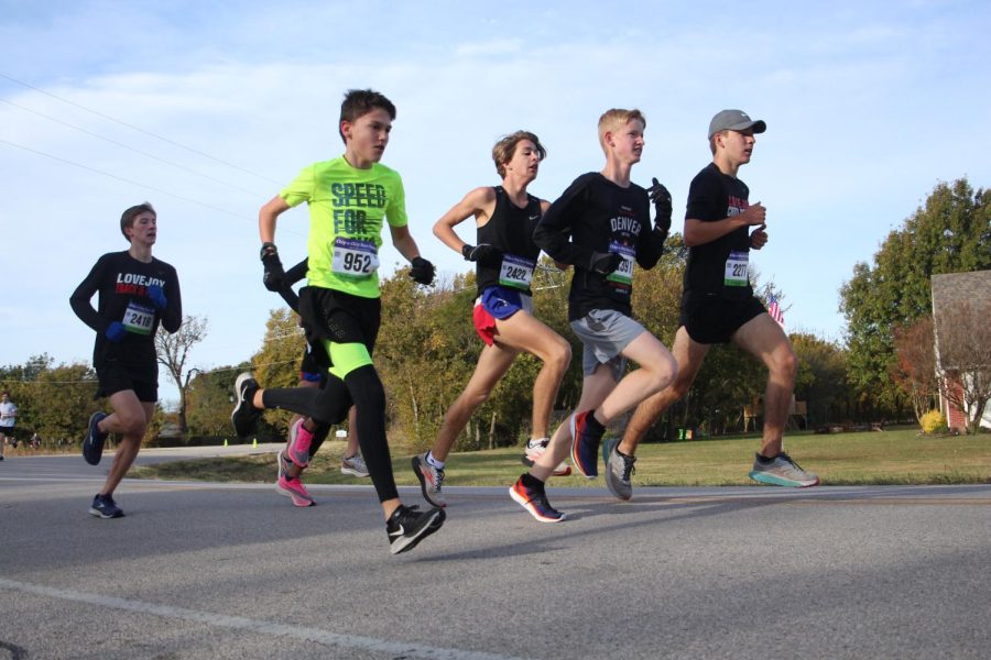 Community member N. Brookner, junior Jack McClure, sophomore TJ Koch and sophomore Sonny Hignite run together during the 5k. All four scored within the top 30 participants in Saturdays race.