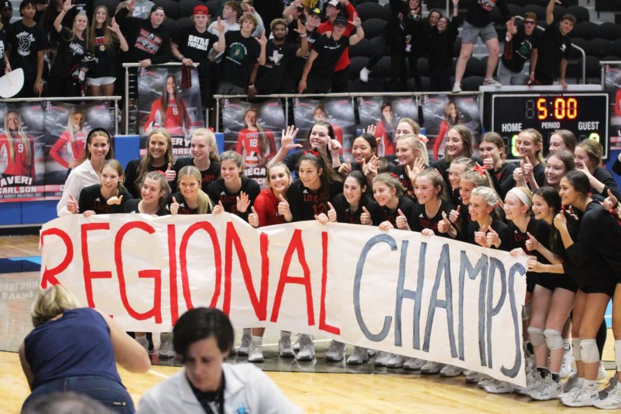 The team holds up the Regional Champs sign after winning the game. The team will play this Friday at the Curtis Culwell Center. 