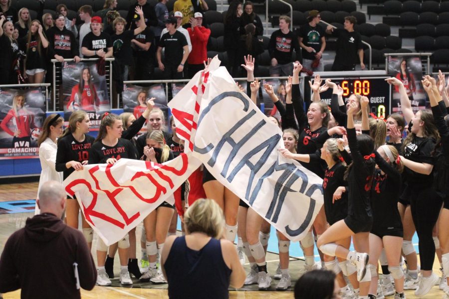 The team rips the Regional Champs sign after the game. The Leopards will play in the state semi-finals on Friday.
