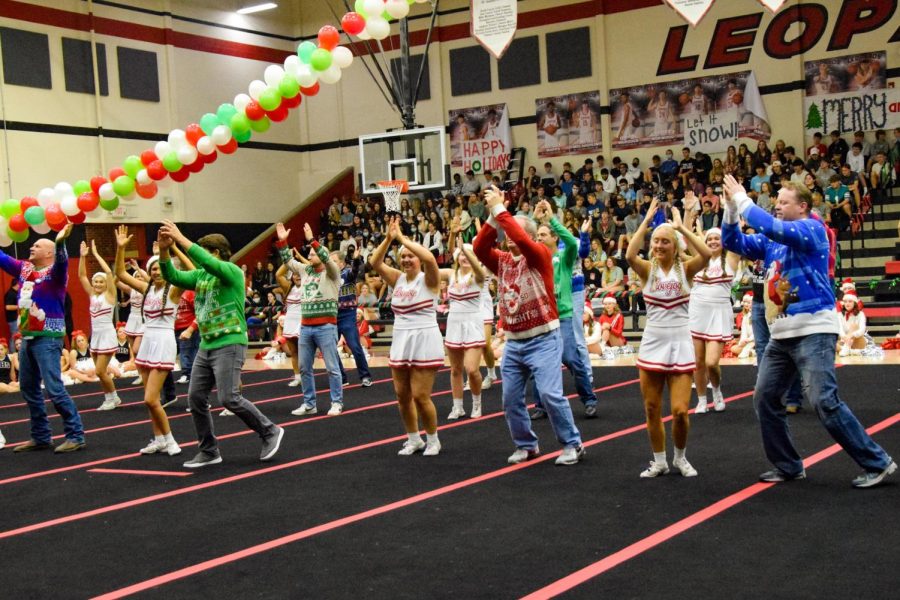 The senior cheerleaders perform a dance with their dads. The final song of the dance was Feliz Navidad.