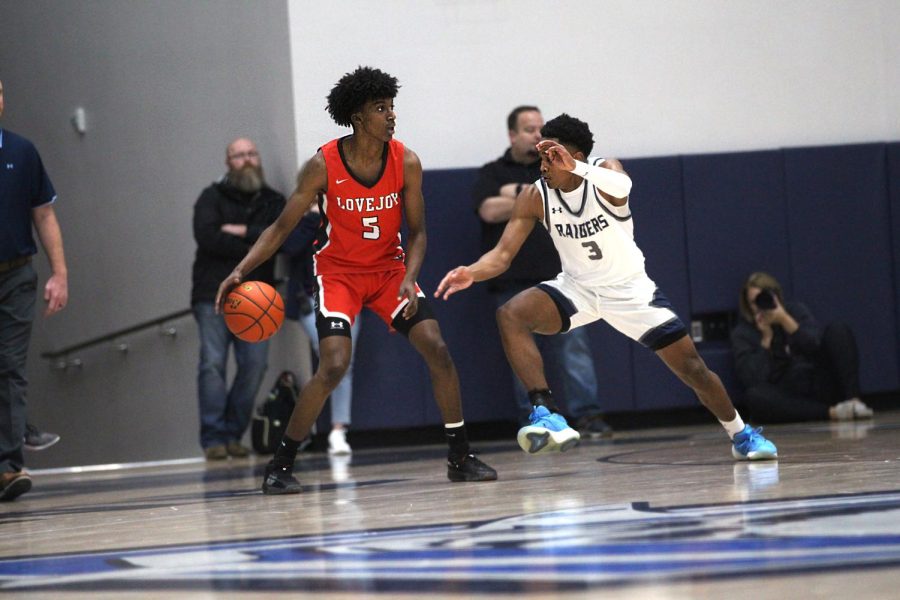 Senior small forward no. 5 Kidus Getenet dribbles the ball past Wylie Easts Anthony Overstreet. The Leopards will play Sherman tomorrow night.